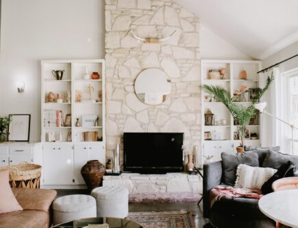 Inviting living room with layered textures, curated decor, and a cozy stone fireplace—an ideal showcase space for new interior designers building a personal brand and portfolio.