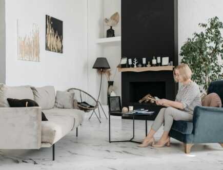 Interior designer reviewing project materials in a stylish modern living room, symbolizing the importance of understanding client personas to tailor home decor services effectively.